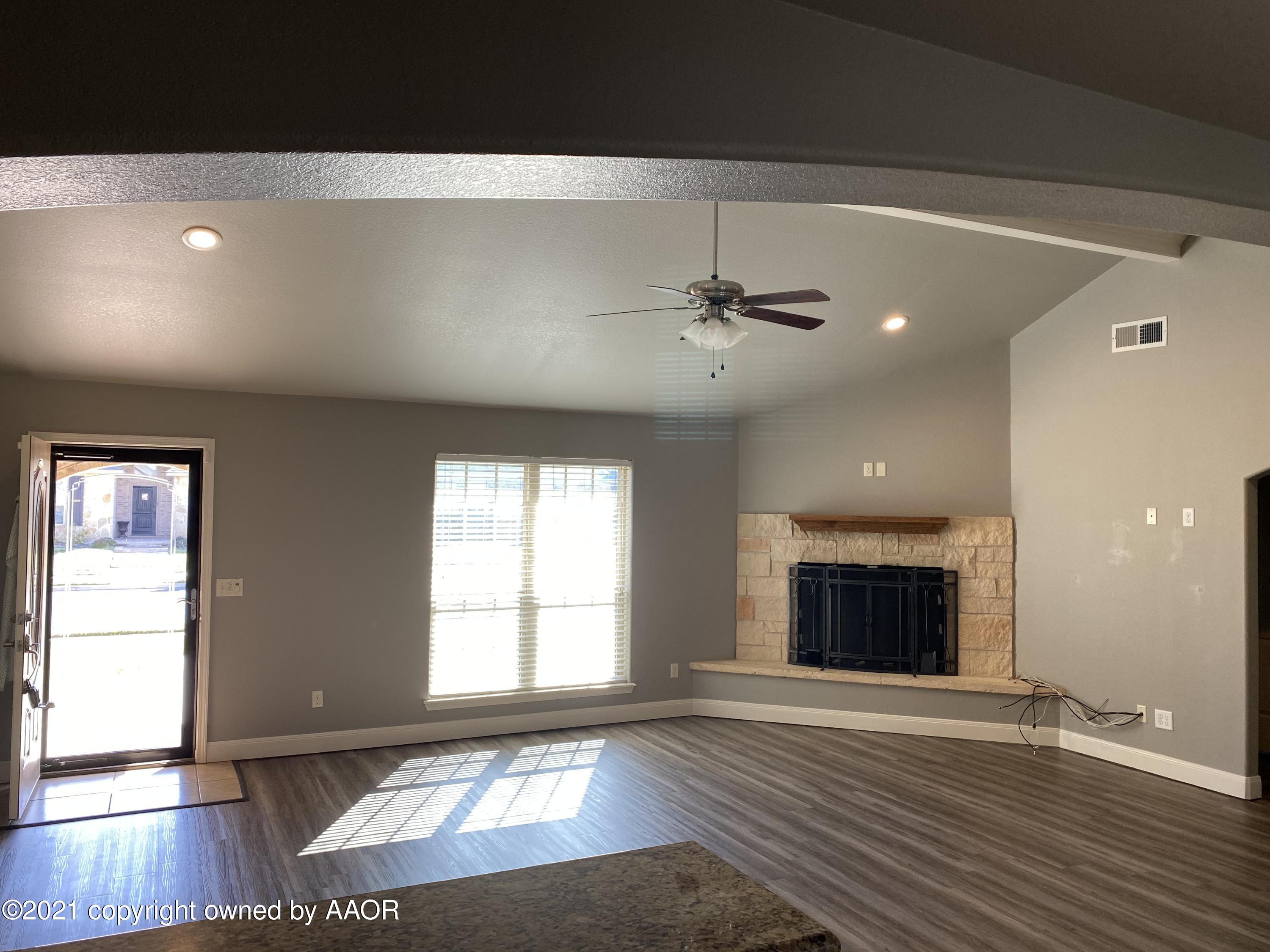 7304 Jacksonhole Drive Amarillo, TX 79118 - Photo 3 of 14 an empty room with wooden floor and windows