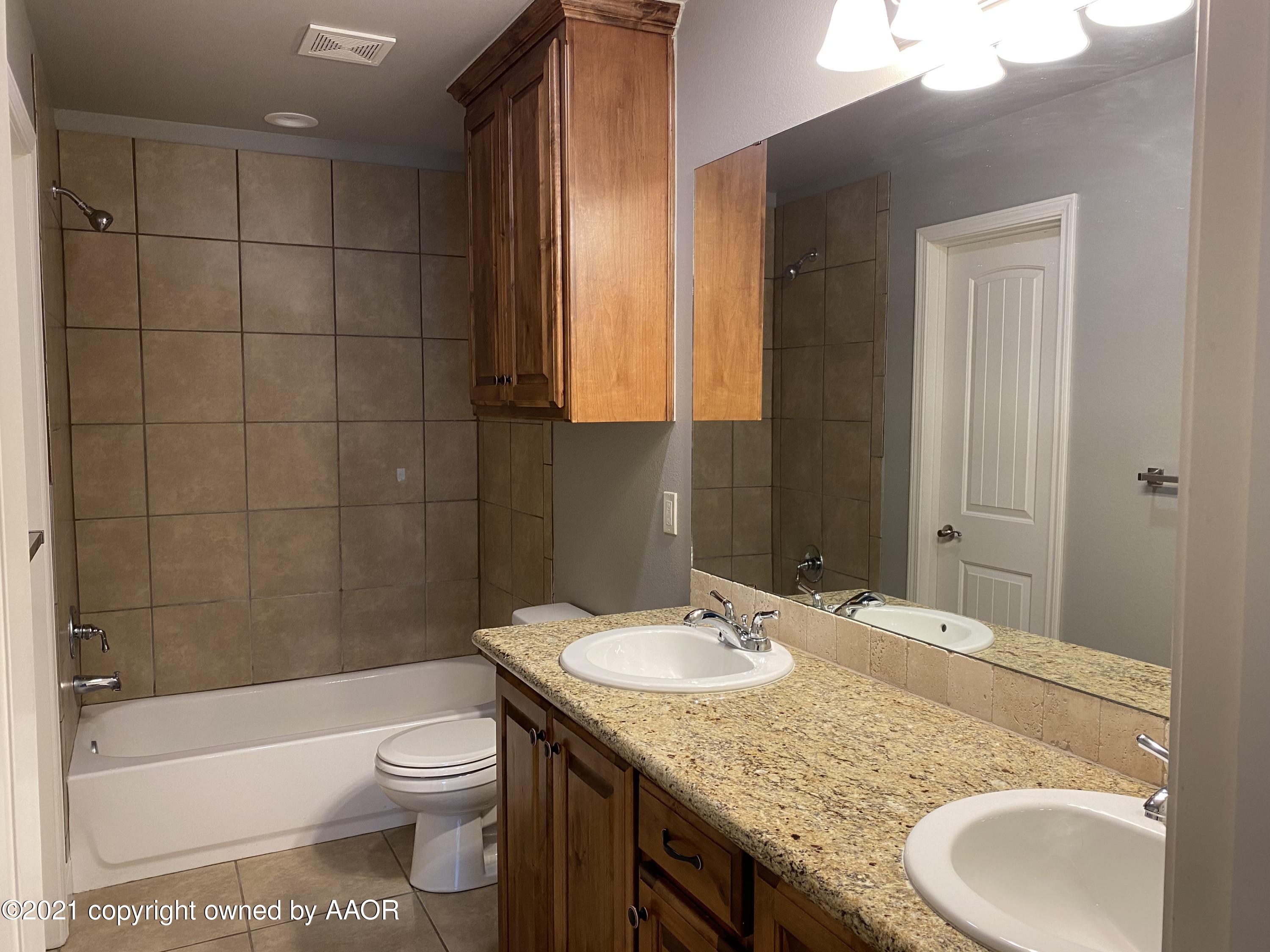 7304 Jacksonhole Drive Amarillo, TX 79118 - Photo 8 of 14 a bathroom with a granite countertop sink toilet and shower