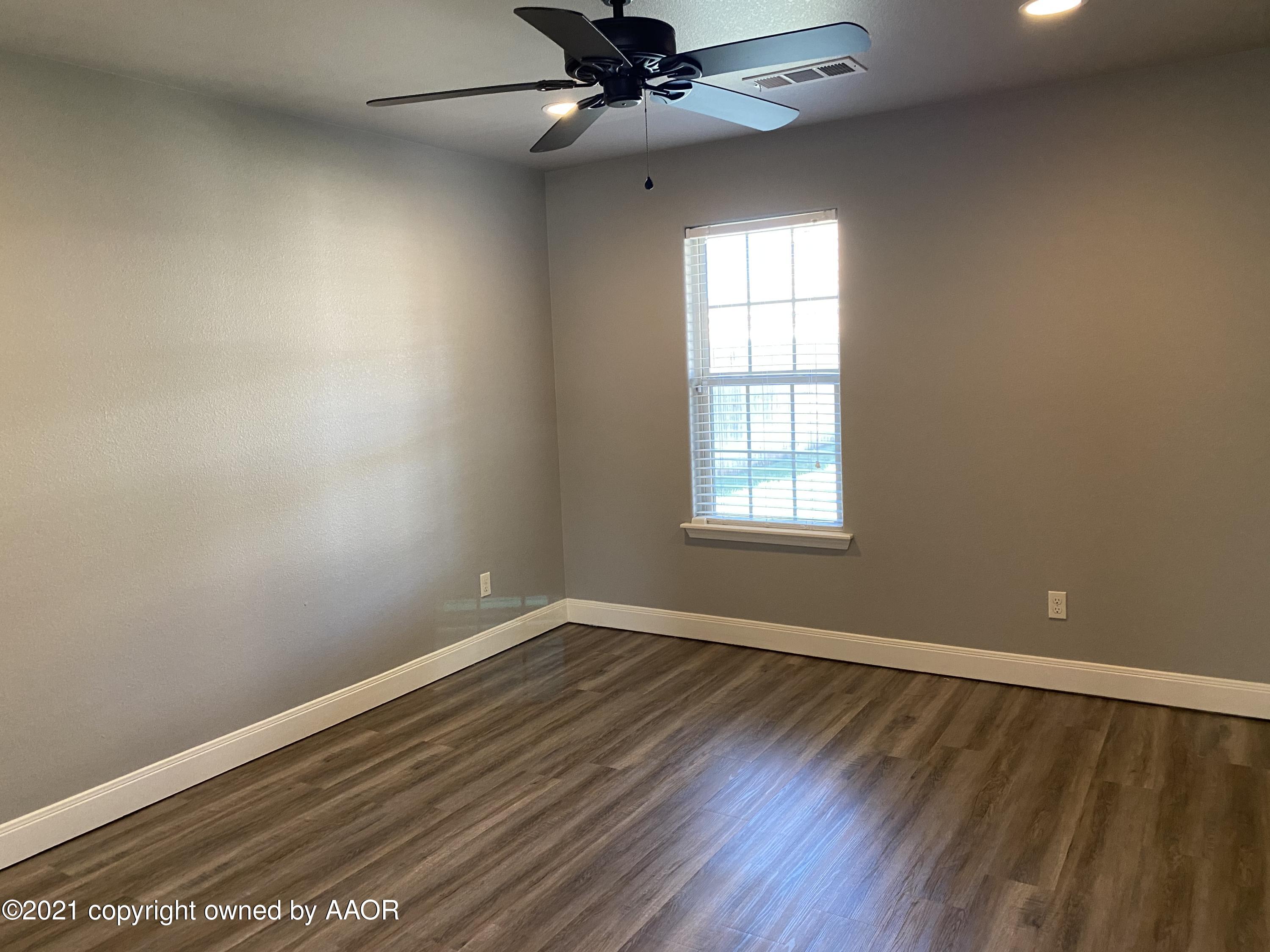 7304 Jacksonhole Drive Amarillo, TX 79118 - Photo 10 of 14 wooden floor in an empty room with a window