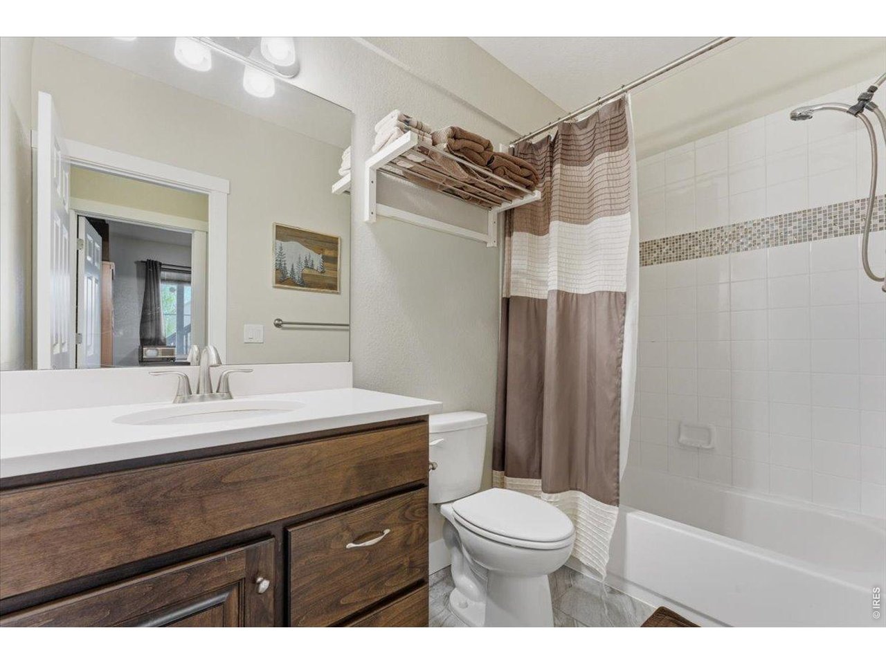 1148 Wagon Bend Road Berthoud, CO 80513 - Photo 36 of 50 a bathroom with a sink a toilet a mirror and shower
