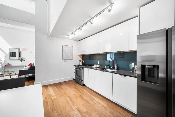 a kitchen with a stove a sink and a refrigerator