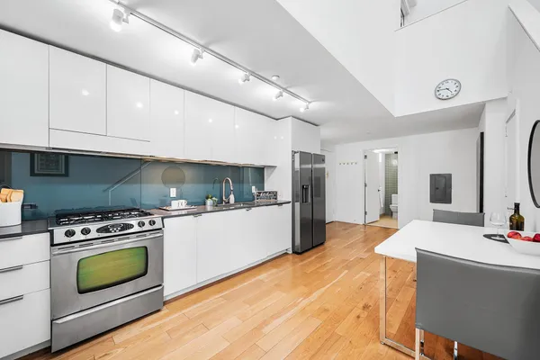 a kitchen with a stove and refrigerator