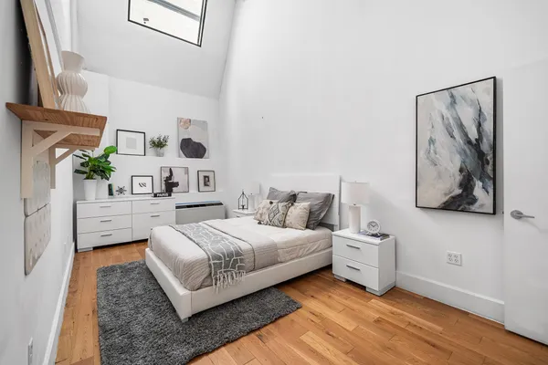 a bedroom with bed and cabinets