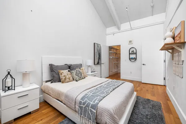 a bedroom with a bed and a wall painting