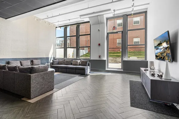 a kitchen with stainless steel appliances kitchen island granite countertop a table and chairs in it