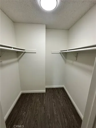 a view of a room with wooden floor and a window