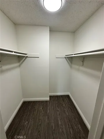 a view of a room with wooden floor and a window