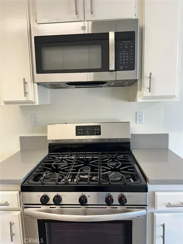 a view of hallway with stairs and wooden floor