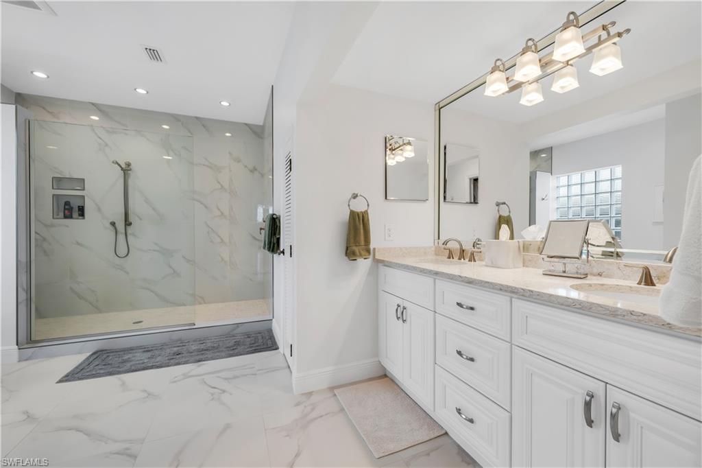 224 Edgemere Way South Naples, FL 34105 - Photo 12 of 35 Bathroom with double vanity, light marble finish floors, recessed lighting, and a marble finish shower