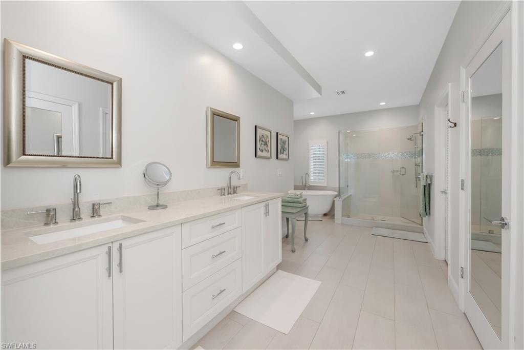 224 Edgemere Way South Naples, FL 34105 - Photo 16 of 35 2nd floor bathroom featuring a stall shower, a soaking tub, double vanity, recessed lighting, and light tile patterned flooring