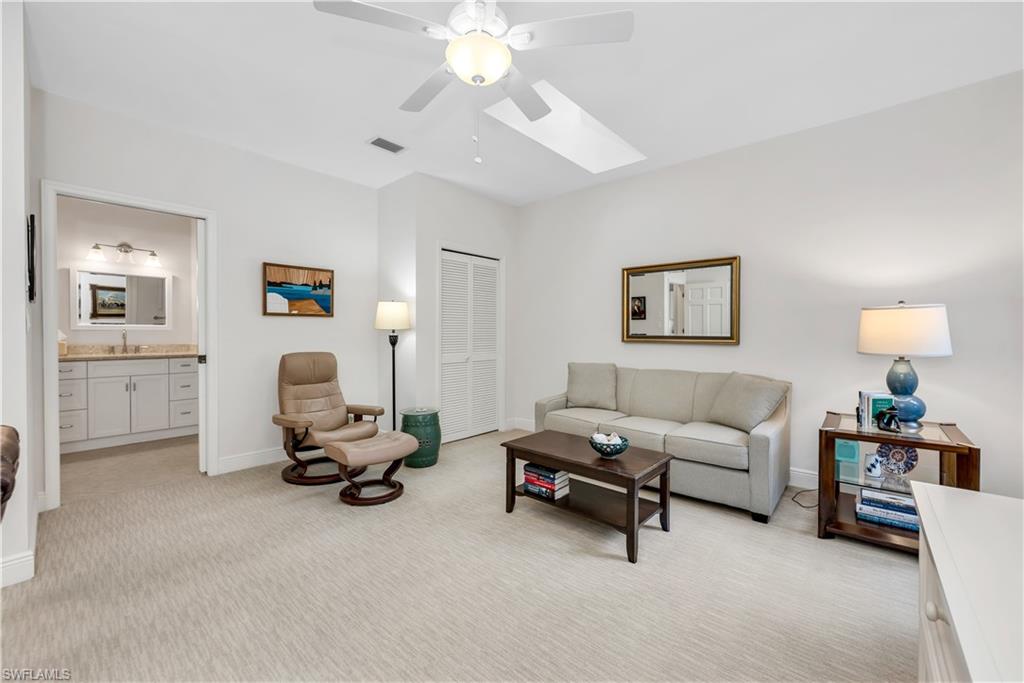 224 Edgemere Way South Naples, FL 34105 - Photo 18 of 35 3rd bedrrom/Den featuring a skylight, light colored carpet, and ceiling fan