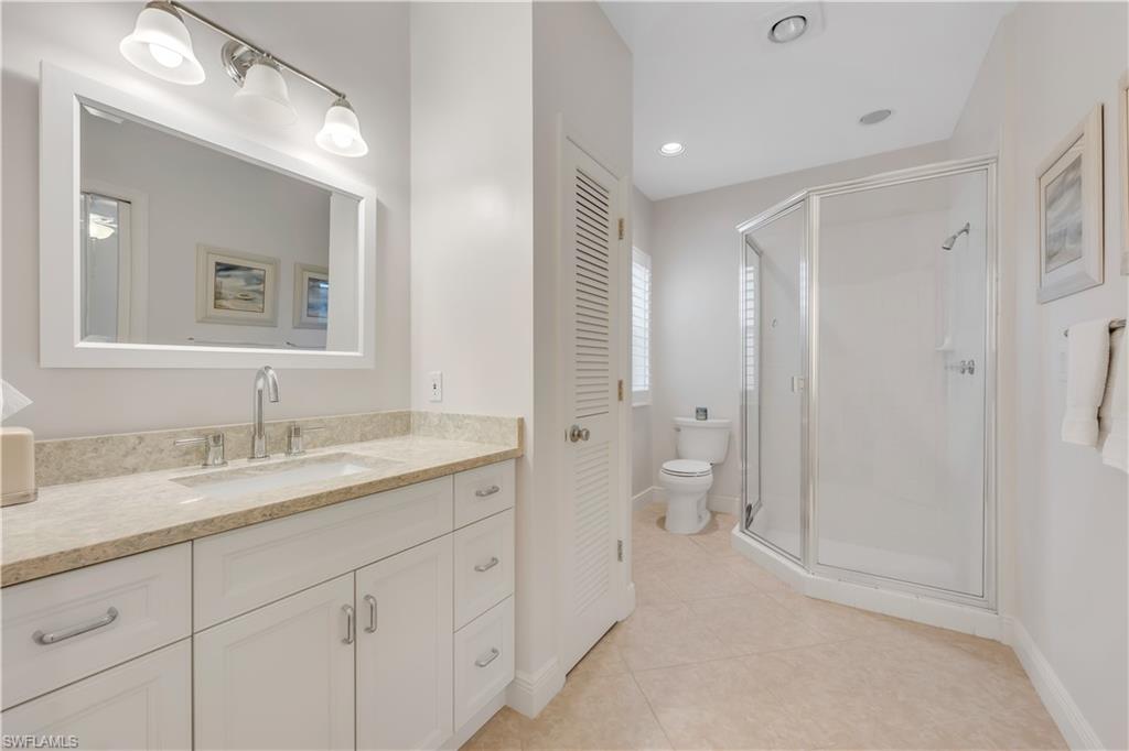 224 Edgemere Way South Naples, FL 34105 - Photo 19 of 35 3rd bathroom featuring vanity, a stall shower, light tile patterned flooring, and recessed lighting
