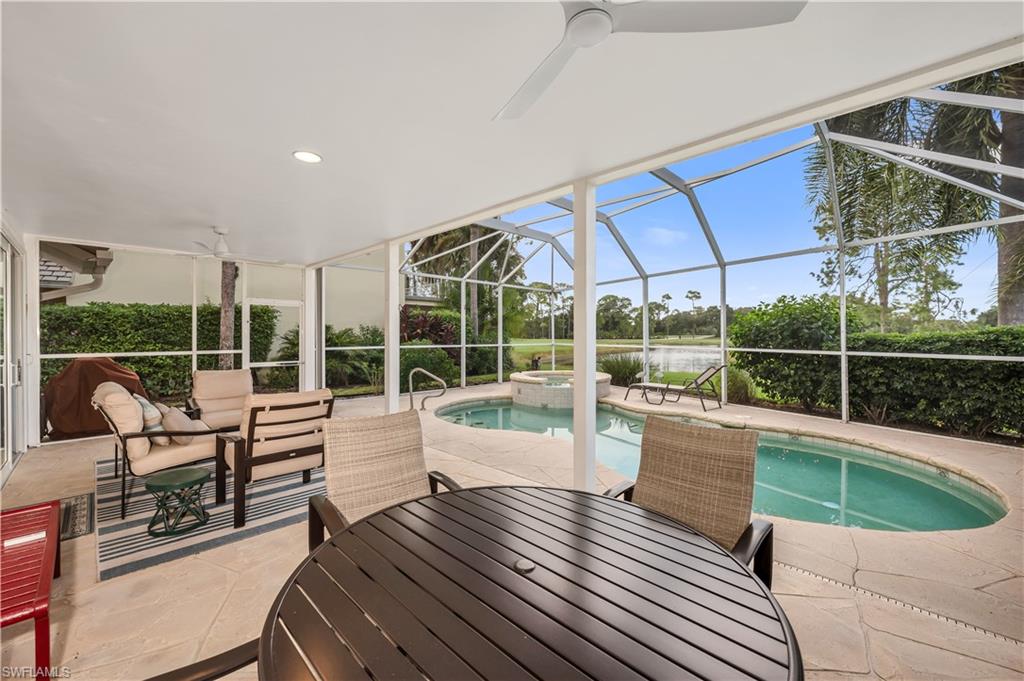 224 Edgemere Way South Naples, FL 34105 - Photo 20 of 35 View of pool featuring outdoor dining space, a patio, a sunroom, a ceiling fan, and glass enclosure