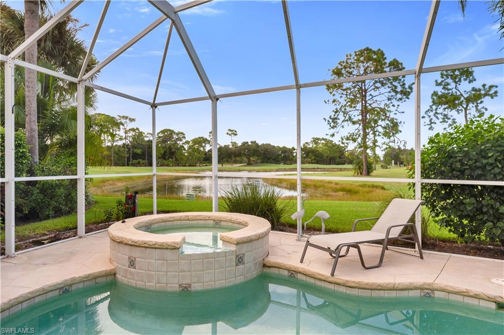 224 Edgemere Way South Naples, FL 34105 - Photo 23 of 35 View of swimming pool with a water view, a lanai, a sunroom, a pool with connected hot tub, and a patio area