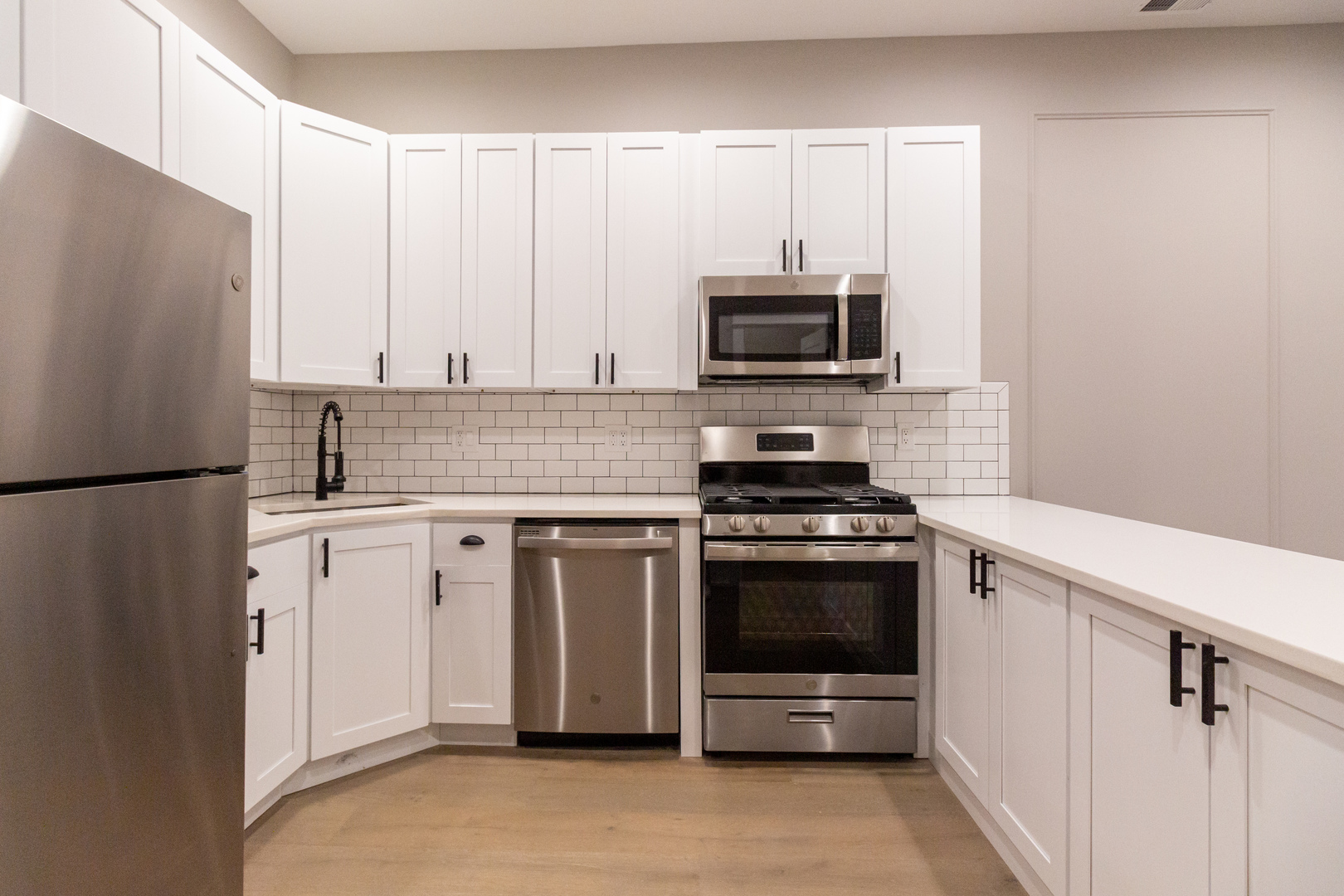 1714 North Spaulding Avenue, Unit 1F Chicago, IL 60647 - Photo 4 of 25 a kitchen with white cabinets and stainless steel appliances
