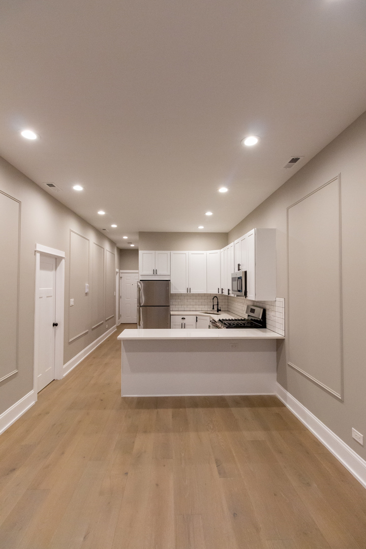 1714 North Spaulding Avenue, Unit 1F Chicago, IL 60647 - Photo 9 of 25 a view of kitchen with kitchen island stainless steel appliances sink and stove