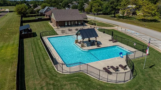a aerial view of a house with swimming pool garden and patio