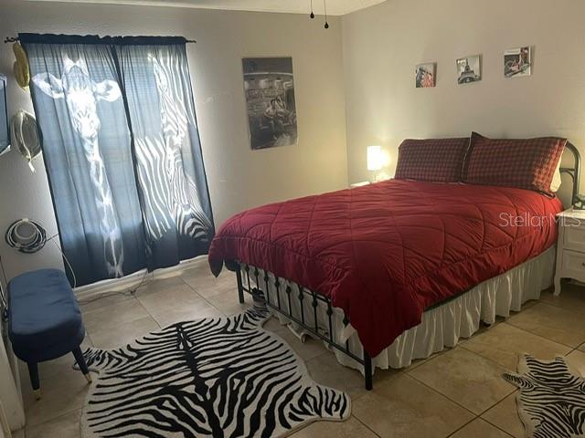 2131 Cascades Boulevard, Unit 301 Kissimmee, FL 34741 - Photo 11 of 30 a bedroom with a bed and a window