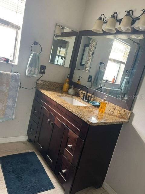 2131 Cascades Boulevard, Unit 301 Kissimmee, FL 34741 - Photo 12 of 30 a view of kitchen with granite countertop sink and a mirror