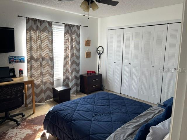 2131 Cascades Boulevard, Unit 301 Kissimmee, FL 34741 - Photo 14 of 30 a bedroom with a bed and a flat tv screen