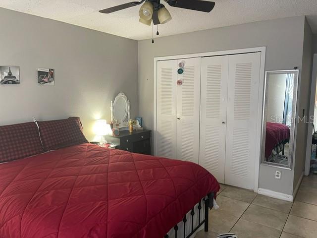 2131 Cascades Boulevard, Unit 301 Kissimmee, FL 34741 - Photo 19 of 30 a bedroom with a bed and a chandelier