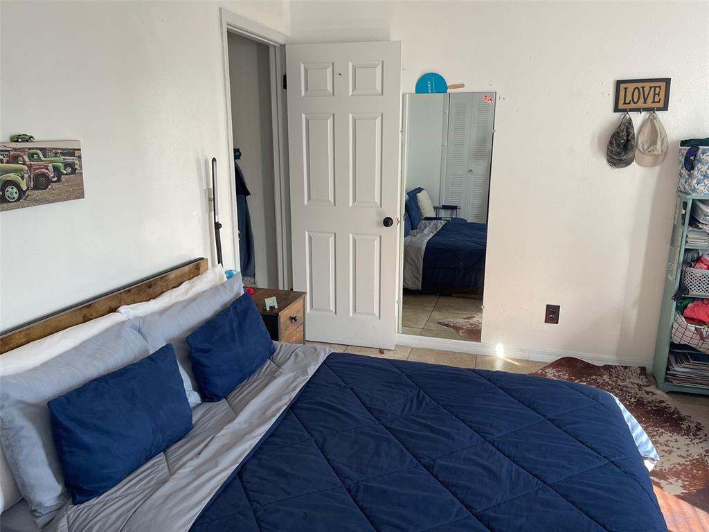 2131 Cascades Boulevard, Unit 301 Kissimmee, FL 34741 - Photo 24 of 30 a bedroom with a bed and a walk in closet