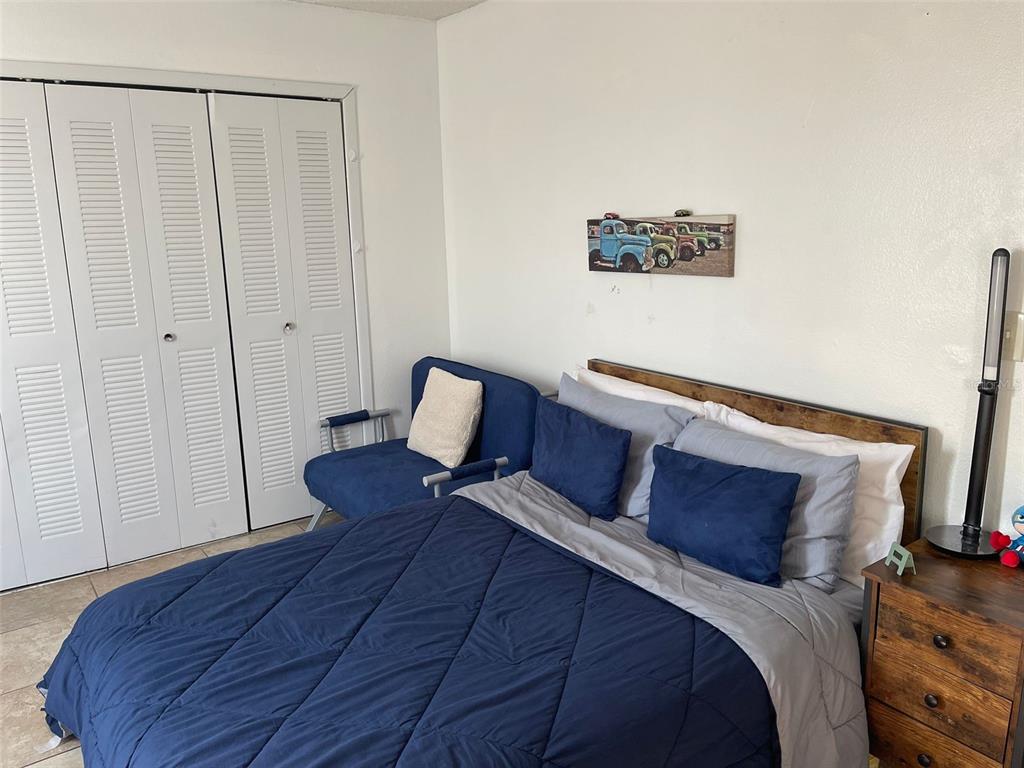 2131 Cascades Boulevard, Unit 301 Kissimmee, FL 34741 - Photo 26 of 30 a bedroom with a bed and a mirror