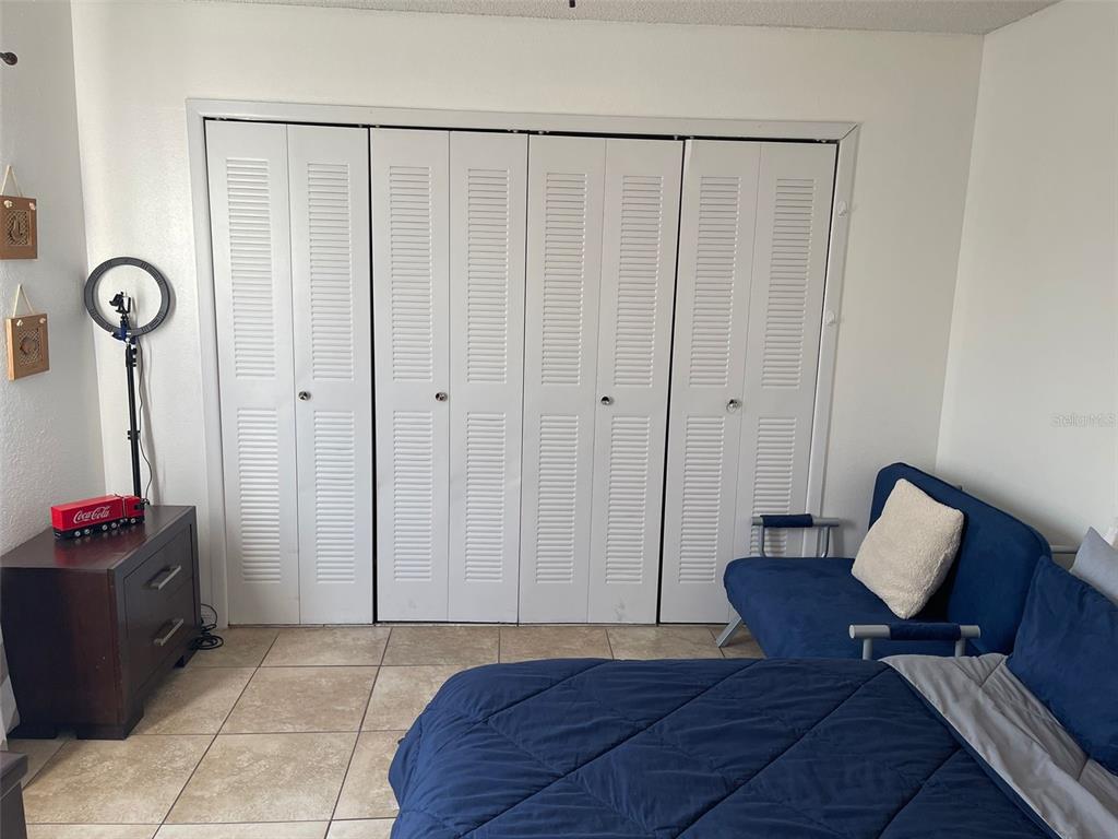 2131 Cascades Boulevard, Unit 301 Kissimmee, FL 34741 - Photo 28 of 30 a bedroom with furniture and a window