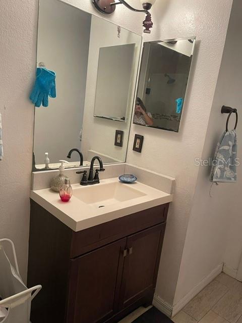 2131 Cascades Boulevard, Unit 301 Kissimmee, FL 34741 - Photo 9 of 30 a bathroom with a sink and a mirror