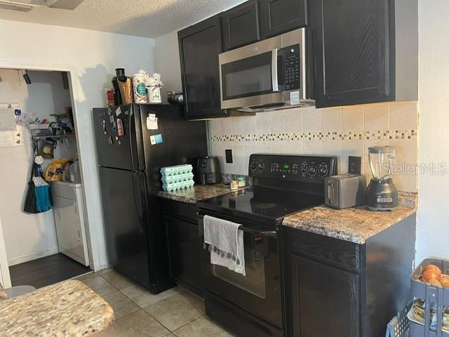 2131 Cascades Boulevard, Unit 301 Kissimmee, FL 34741 - Photo 10 of 30 a kitchen with refrigerator and microwave