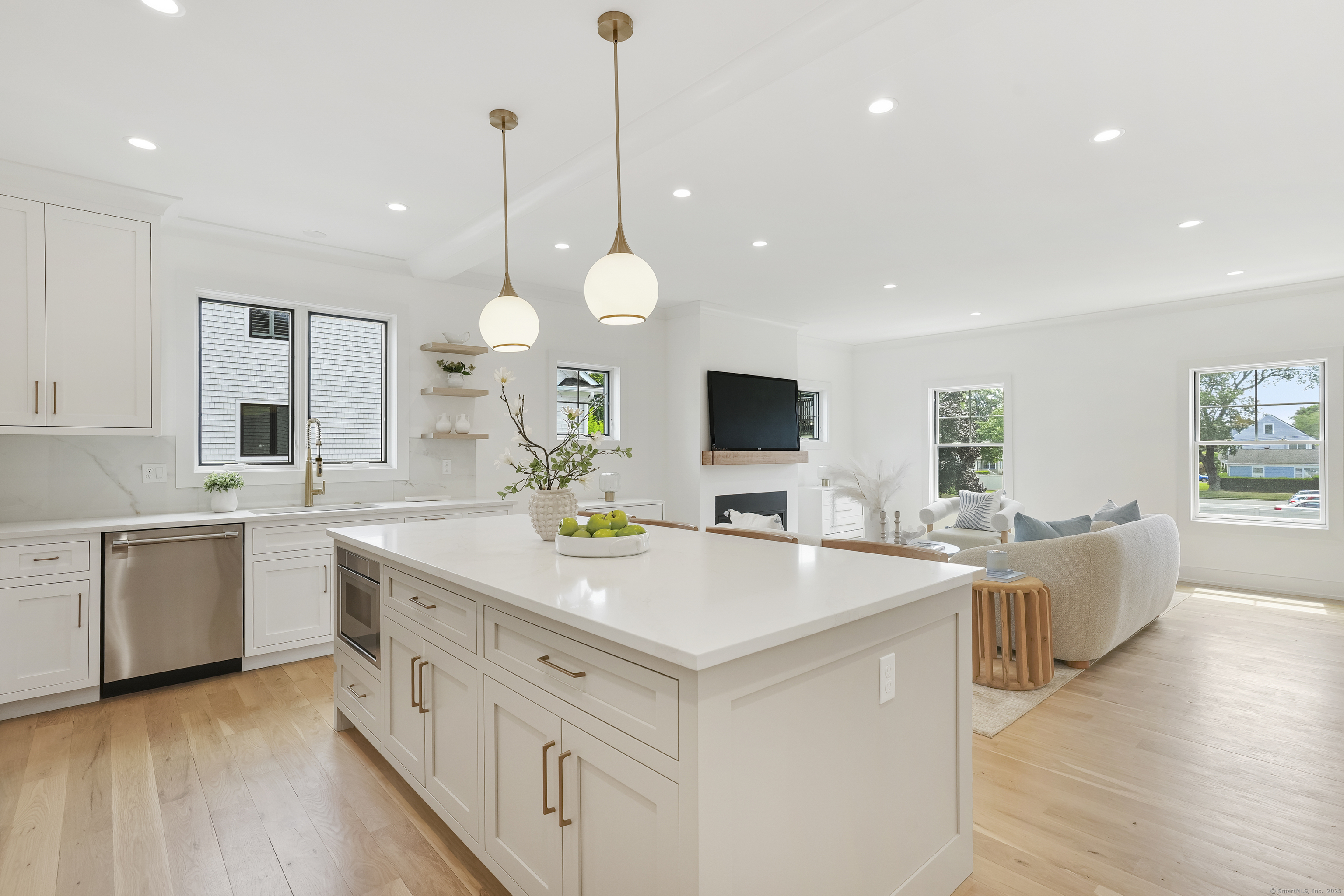 13 Terhune Drive Westport, CT 06880 - Photo 12 of 28 a kitchen with kitchen island granite countertop a sink cabinets and wooden floor