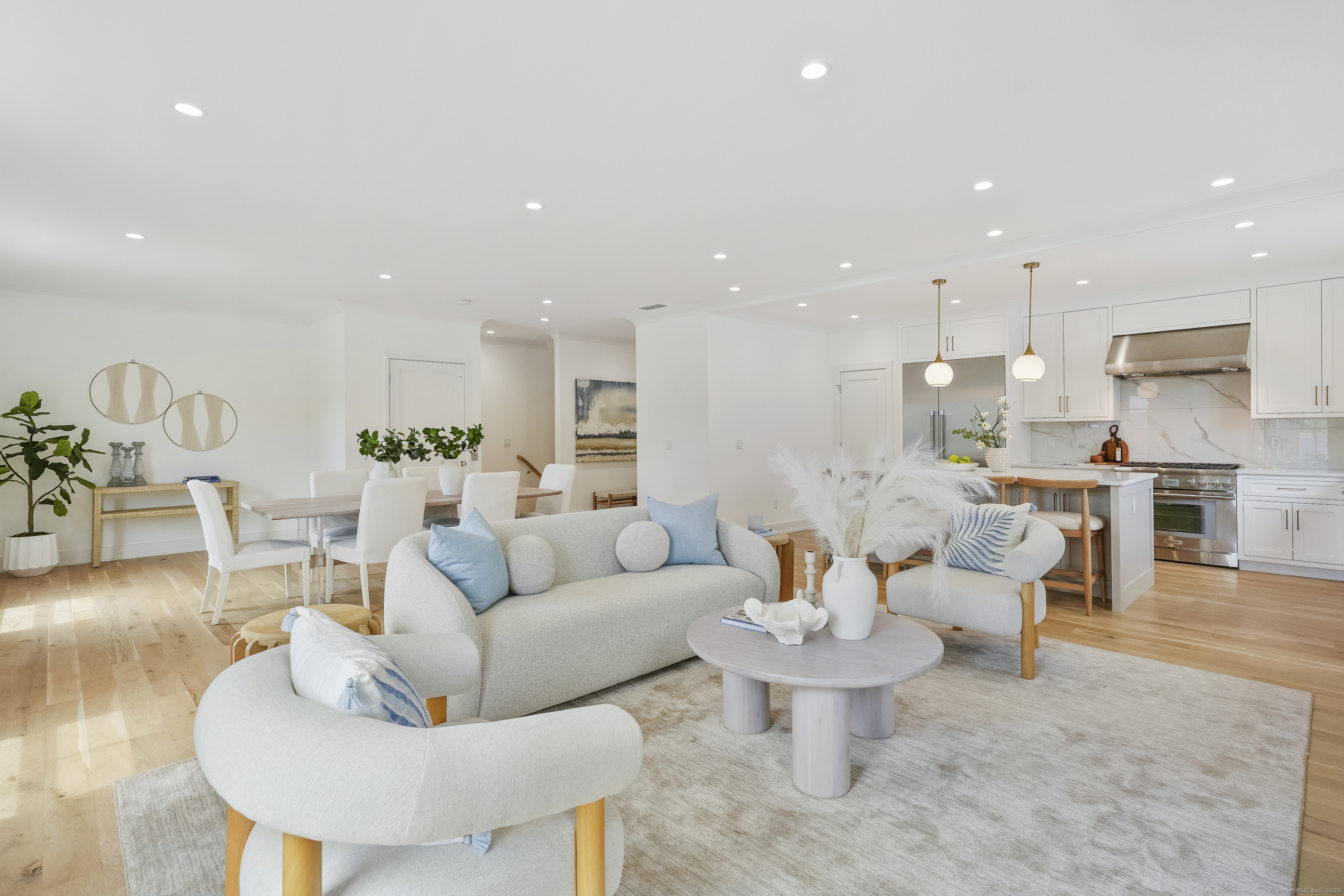 13 Terhune Drive Westport, CT 06880 - Photo 14 of 28 a living room with furniture and a dining table with kitchen view