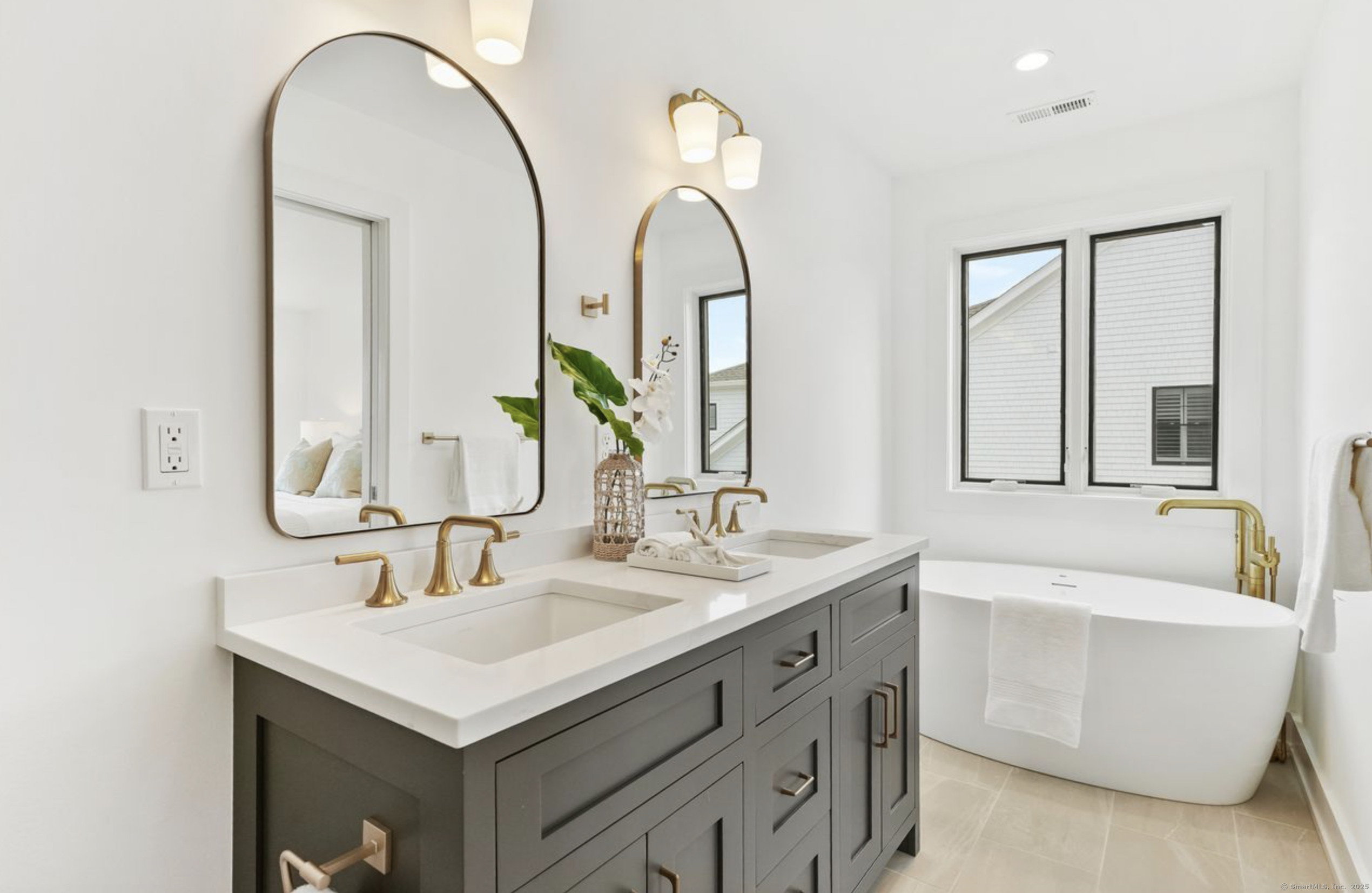 13 Terhune Drive Westport, CT 06880 - Photo 17 of 28 a bathroom with a double vanity sink and a mirror