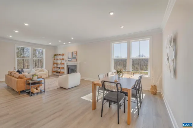 a dining room with furniture and wooden floor