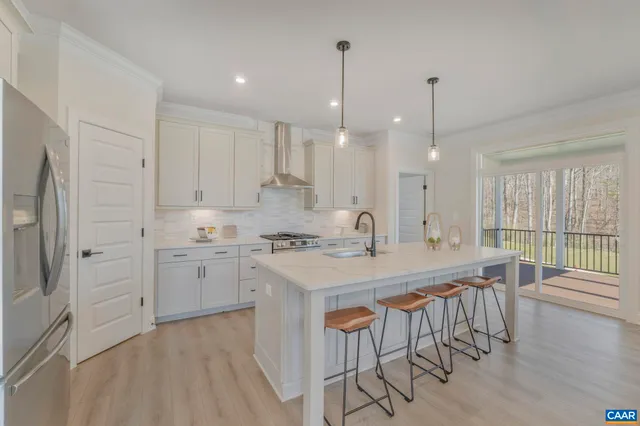 a kitchen with center island white cabinets and stainless steel appliances