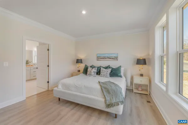 a bedroom with a bed and a large window