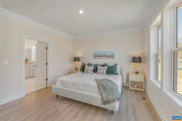 a bedroom with a bed and a large window