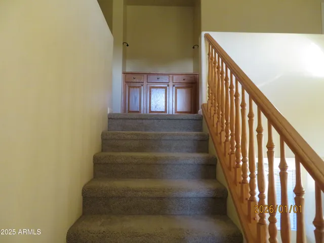 a view of a chairs and table in the back yard of the house