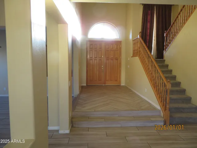 a view of a hallway with wooden floors