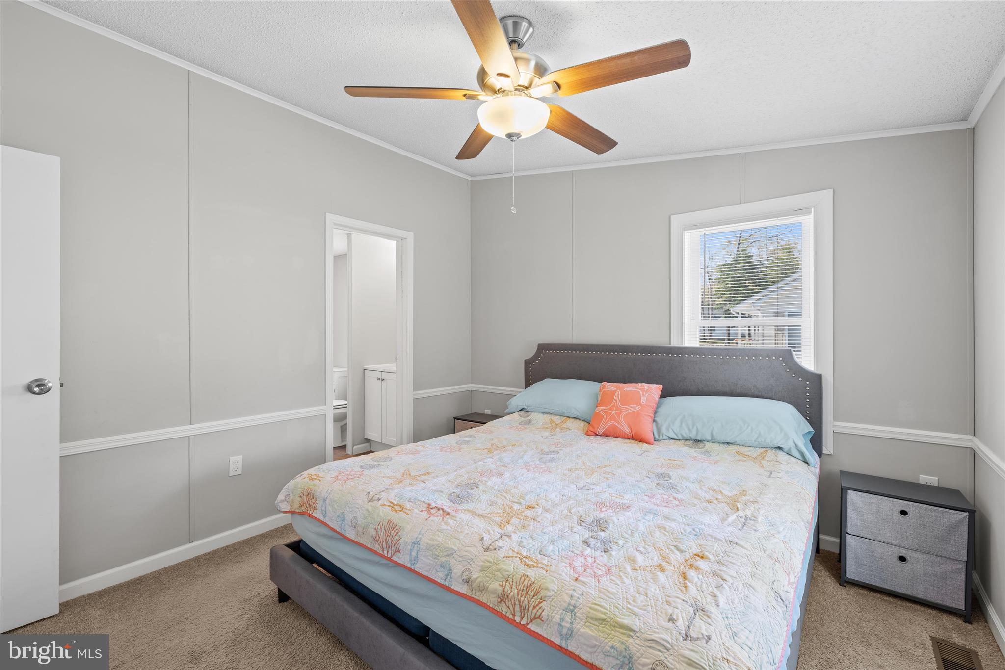 30 Woodlyn Road Millsboro, DE 19966 - Photo 19 of 44 a bedroom with a large bed and a chandelier