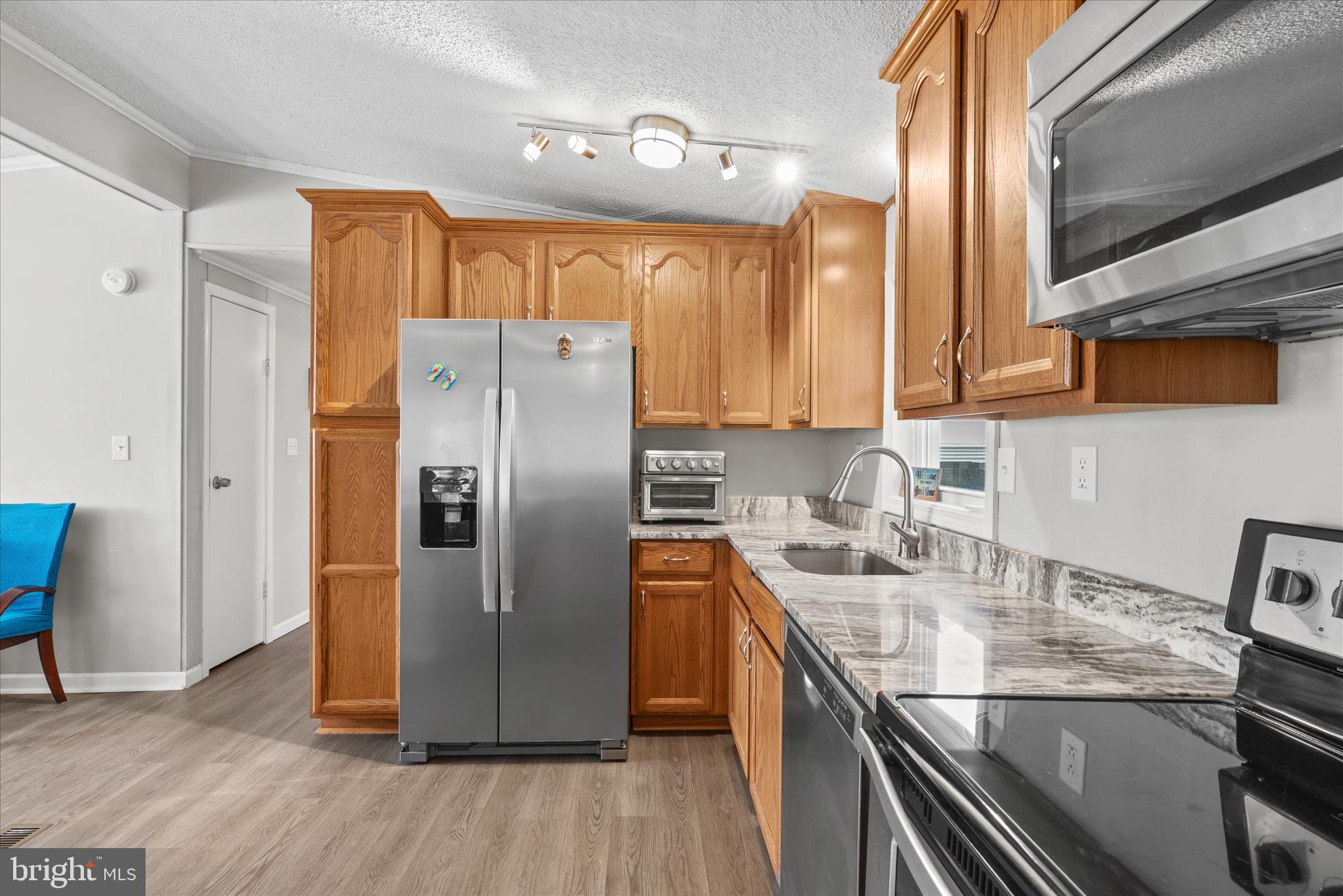 30 Woodlyn Road Millsboro, DE 19966 - Photo 2 of 44 a kitchen with stainless steel appliances granite countertop a refrigerator a sink and a stove
