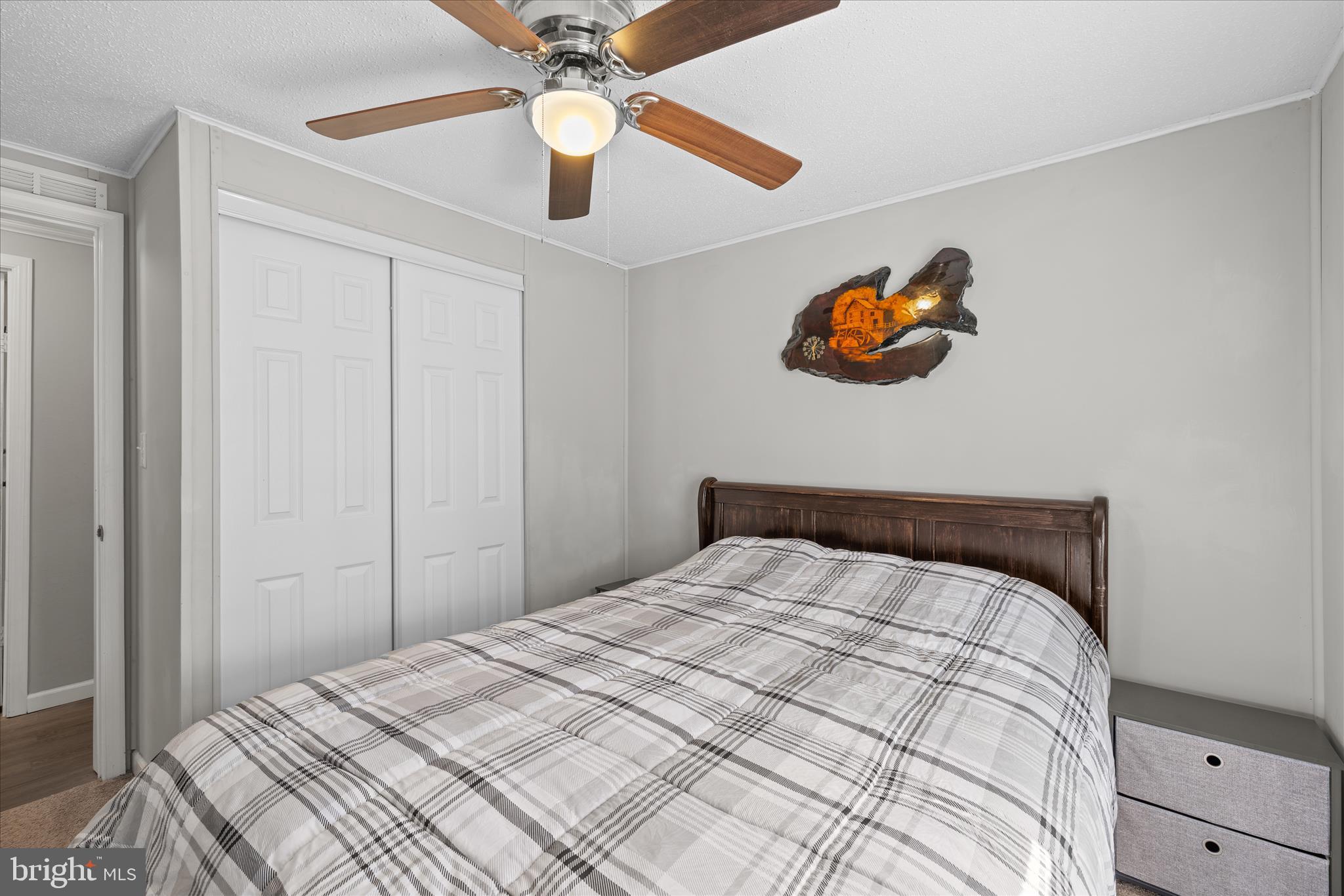 30 Woodlyn Road Millsboro, DE 19966 - Photo 22 of 44 a bedroom with a bed and a chandelier