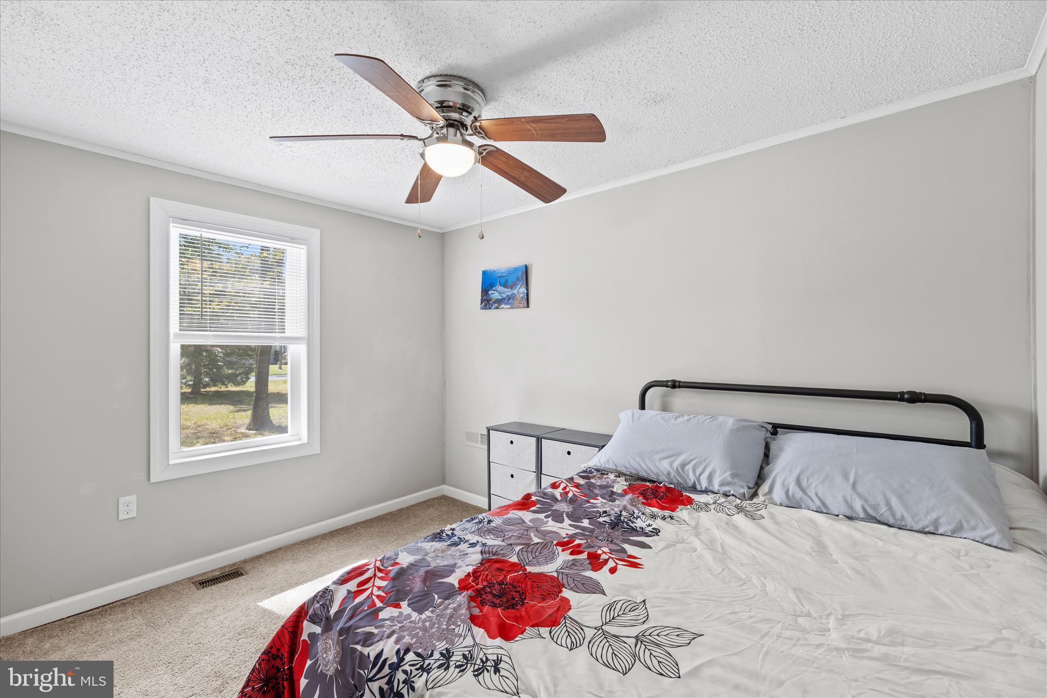 30 Woodlyn Road Millsboro, DE 19966 - Photo 24 of 44 a bedroom with a bed and a chandelier