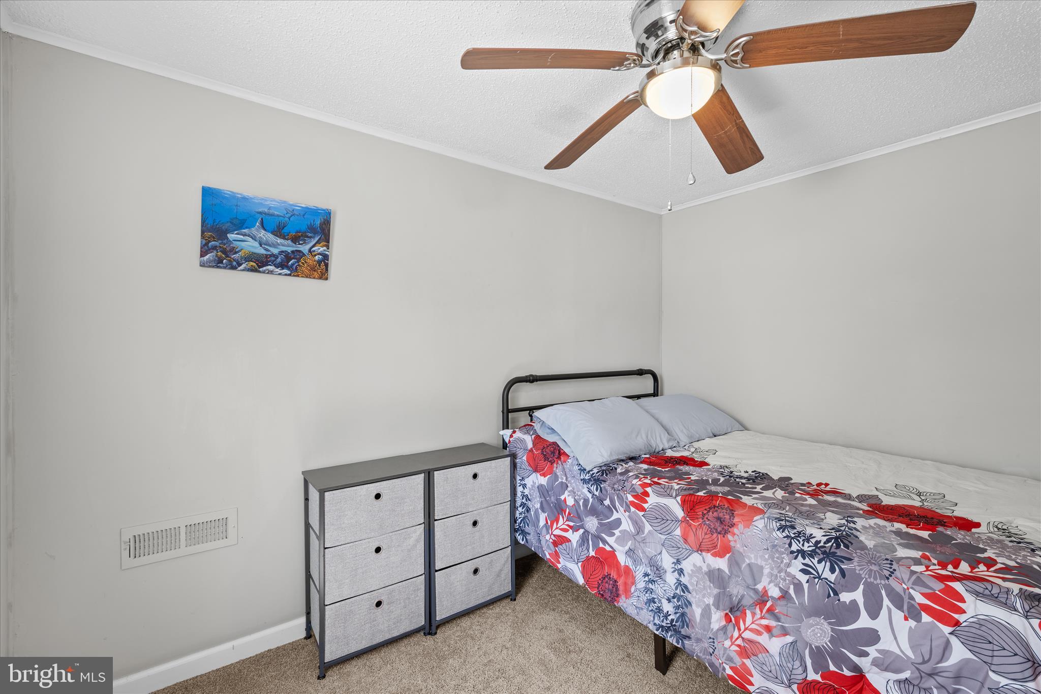 30 Woodlyn Road Millsboro, DE 19966 - Photo 25 of 44 a bedroom with a bed and a chandelier