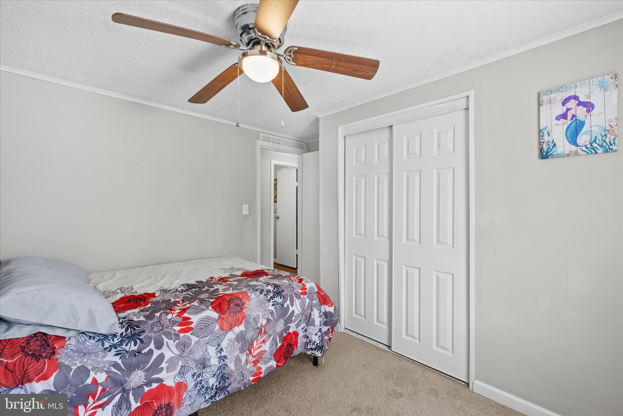 30 Woodlyn Road Millsboro, DE 19966 - Photo 26 of 44 a bedroom with a bed and a chandelier