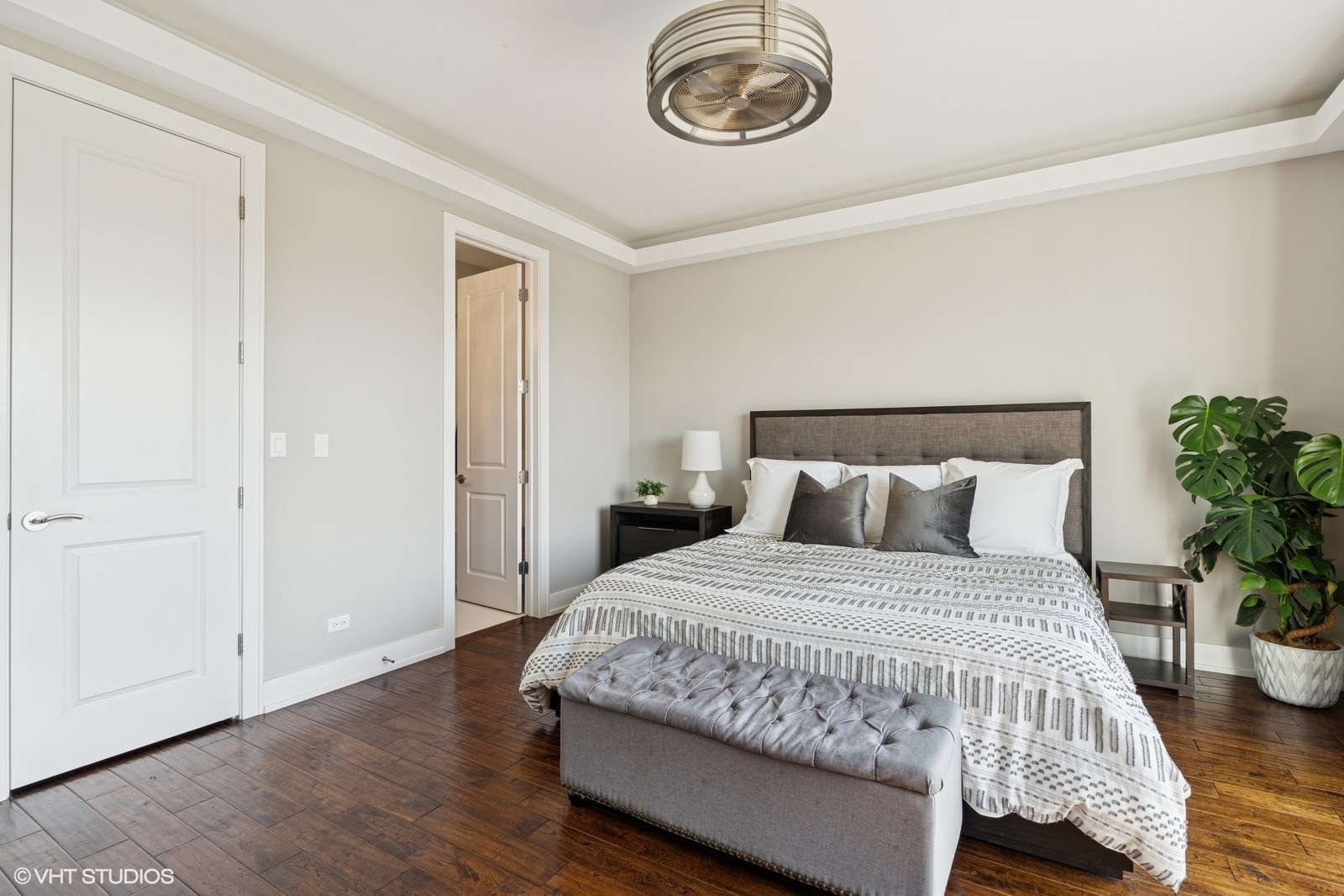 Undisclosed Address Chicago, IL 60657 - Photo 12 of 27 a bedroom with a bed and a chandelier