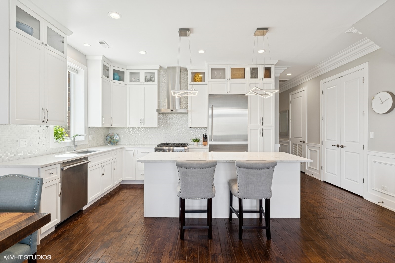 Undisclosed Address Chicago, IL 60657 - Photo 3 of 27 a large white kitchen with a white stove top oven and white cabinets