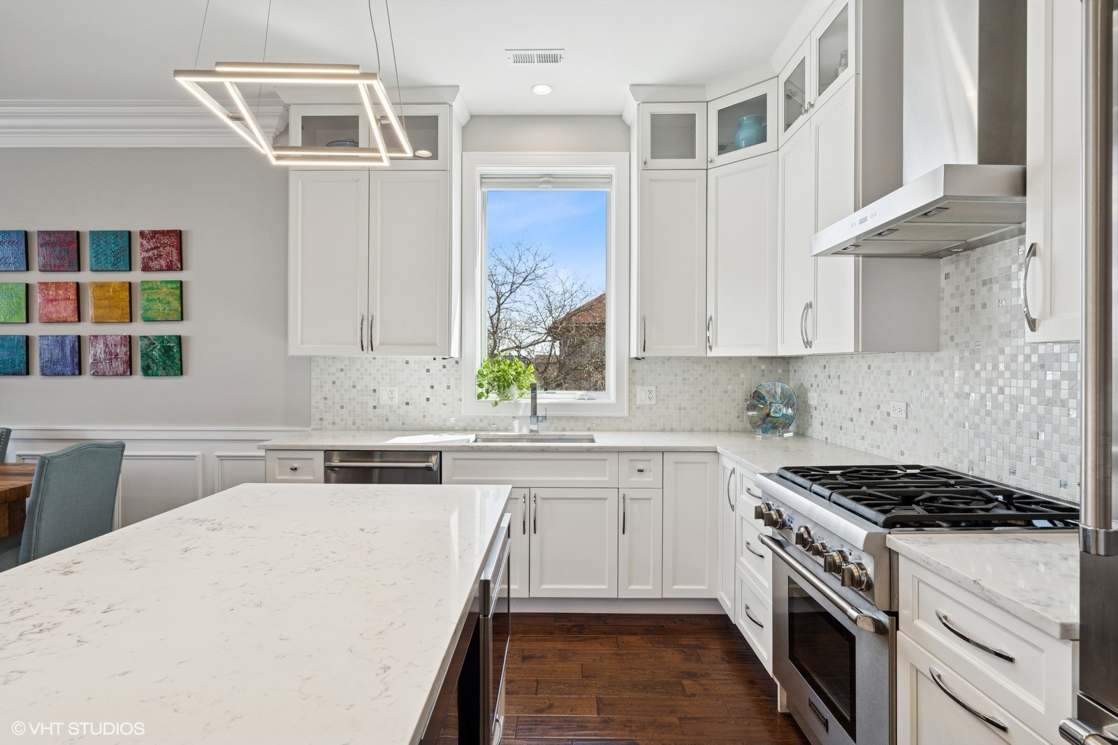 Undisclosed Address Chicago, IL 60657 - Photo 5 of 27 a kitchen with stainless steel appliances a sink stove and cabinets