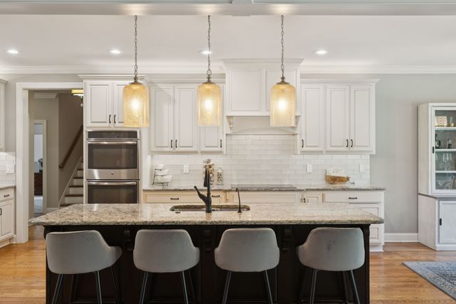 a spacious bedroom with a bed and a chandelier