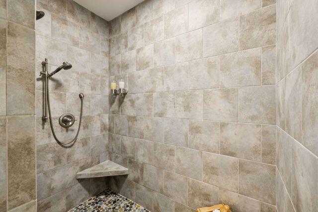 a view of swimming pool with lawn chairs and large trees